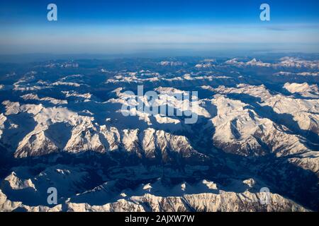 Aerial view of Dolomites mountain range from airplane window. Stock Photo