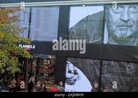 Photographer David Bailey advert on the front of Flannels store and shoppers outside the entrance in Oxford Street London England UK 2019 KATHY DEWITT Stock Photo