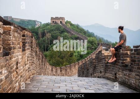 Traveler at the Great Wall of China near Beijing, China. Stock Photo
