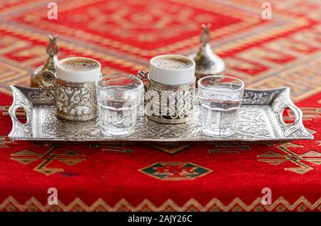 Two Cups with traditional Turkish Beverage Turkish Coffee on the Table Stock Photo