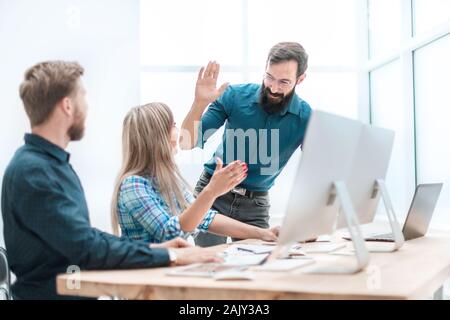 business colleagues giving each other a high five Stock Photo