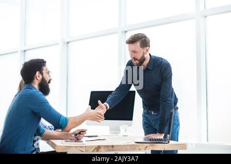 business people shaking hands over the Desk Stock Photo