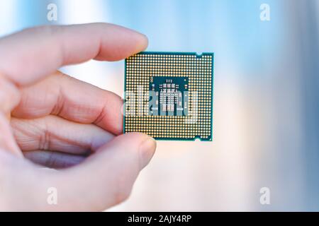 Hand holding CPU.  desktop CPU,  processoor. Informatic chip, PC component. Micro chip. Stock Photo