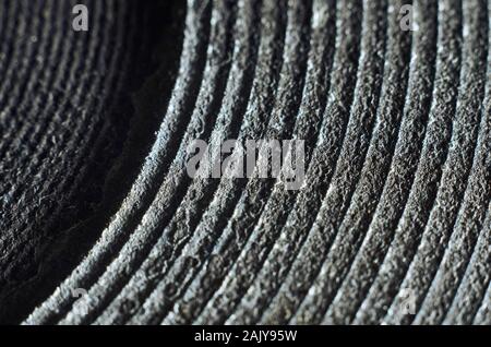 Macro of old and damaged metal heating element from electric range. Abstract repeating pattern of rings Stock Photo