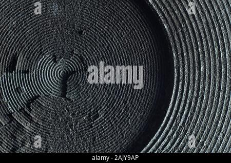 Macro of old and damaged metal heating element from electric range. Surface layers peeling away Stock Photo