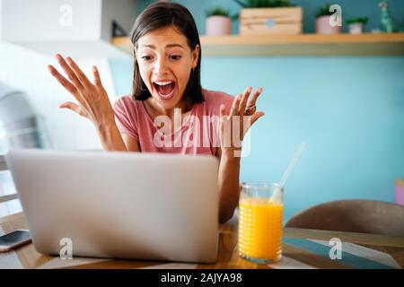 Portrait young stressed displeased worried business woman sitting in front of laptop