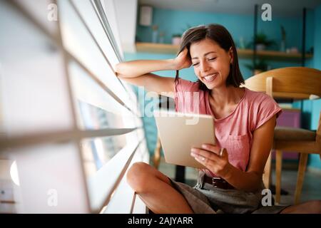 Portrait of cheerful woman using portable pc for blogging in social networks Stock Photo