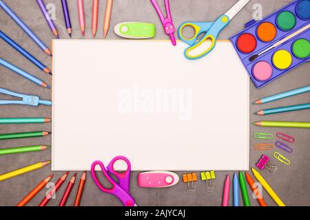 Back to school - White drawing block and school and art supplies on grey background Stock Photo