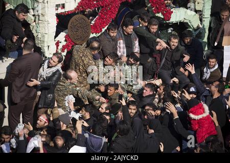 Tehran, Iran. 6th Jan, 2020. Iranians attend the funeral ceremony of slain Iranian Revolutionary Guards Corps (IRGC) Lieutenant general and commander of the Quds Force Qasem Soleimani and of other victims in Tehran, Iran. Soleimani was killed in a targeted US airstrike on 03 January 2020 in Baghdad, Iraq. The processions mark the first time Iran honored a single man with a multi-city ceremony. Not even Ayatollah Ruhollah Khomeini, who founded the Islamic Republic, received such a processional with his death in 1989. Credit: Rouzbeh Fouladi/ZUMA Wire/Alamy Live News Stock Photo