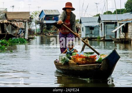 Boots are the way to carry goods across the Tonle Sap River Stock Photo