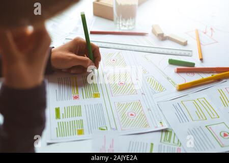 The designer develops web applications for mobile phones. Sketch user interface for smartphones. Stock Photo