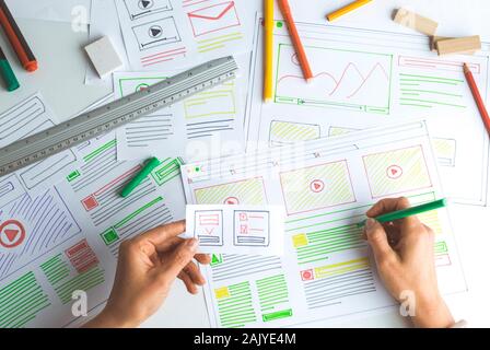 The designer develops web applications for mobile phones. Sketch user interface for smartphones. Stock Photo