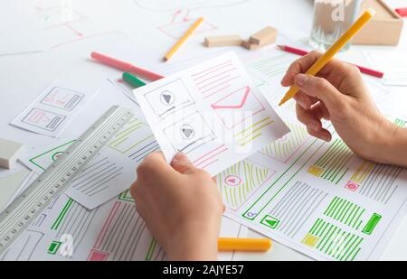 The designer develops web applications for mobile phones. Sketch user interface for smartphones. Stock Photo