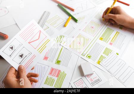 Design and creation of web sites. The designer draws application sketches. Stock Photo