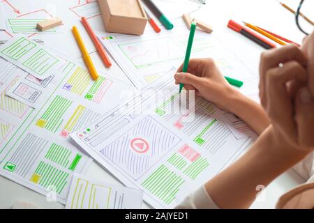 The designer develops web applications for mobile phones. Sketch user interface for smartphones. Stock Photo