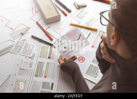 The designer develops web applications for mobile phones. Sketch user interface for smartphones. Stock Photo