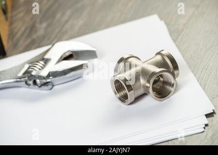 Plumbing pipeline element and adjustable wrench Stock Photo