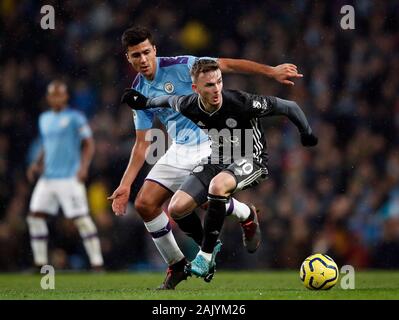 Leicester City's James Maddison (right) and Manchester City's Rodrigo battle for the ball during the Premier League match at the Etihad Stadium, Manchester. Stock Photo