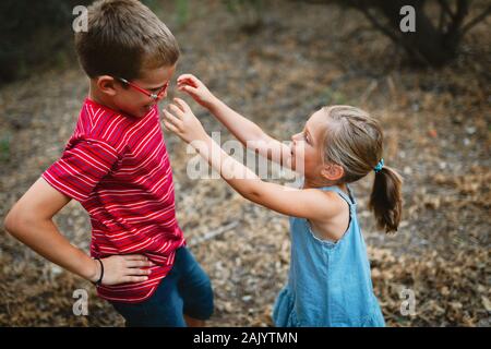 Two kids playing and dancing in the forest Stock Photo