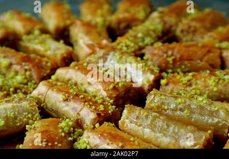 Closeup Heap of Baklava Pastries Topped with Chopped Pistachio Nuts Stock Photo