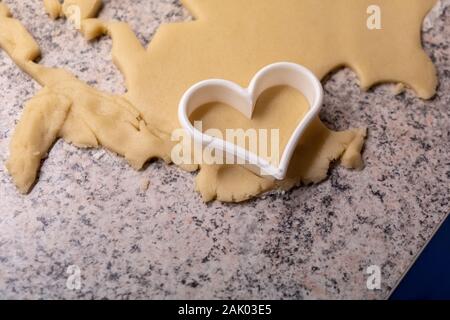 Moulds, hearts, flour and dough for Christmas biscuits Stock Photo