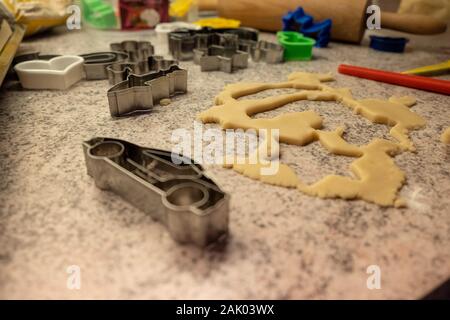 dough and cookie cutter with a kitchen roll an flour for baking cookies for christmas Stock Photo