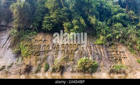 Ancient 15th century carvings of Hindu deities on the steep walls of the hills lining Gomti river in Chabimura in Tripura, India.