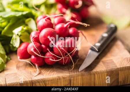 Fresh bundles of radish laid on a kitchen table