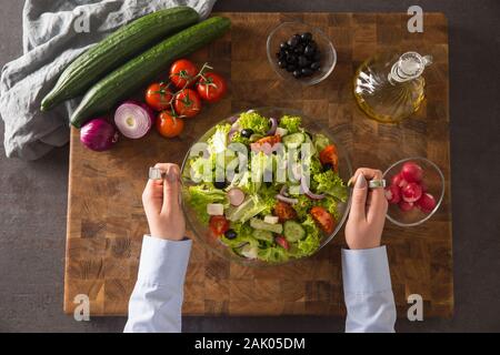 Top of view female hand mixed fresh vegetable salad Stock Photo