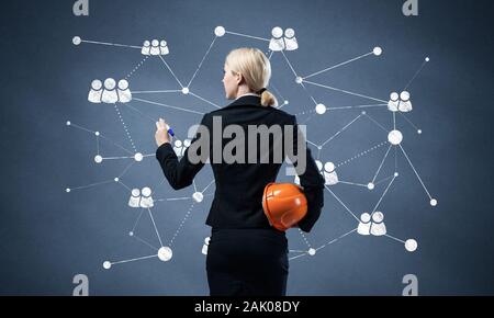 Businesswoman designing social network interaction Stock Photo