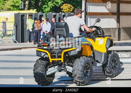 Korolev, Russia - May 18, 2019: Man on the ATV Quad Bike at loading process to the freight truck Stock Photo