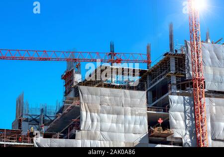 Workers are working on construction sites  in the structural steel beam build large residential buildings. Stock Photo
