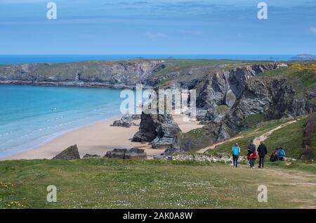 Hikers walking on the South West Coast Path near Bedruthan Steps on the coast of north Cornwall, England, UK Stock Photo