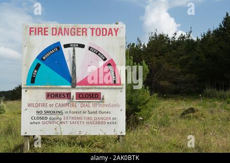 Muriwai, West Coast, Auckland, Northland, New Zealand. High fire danger today forest closed no smoking no campfires warning sign extreme very high Stock Photo