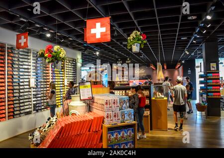 Broc, Switzerland - July 27, 2019: Visitors of the famous Cailler chocolate factory buying chocolate souvenirs in the local shop. People choosing Swiss chocolates in the factory store. Stock Photo