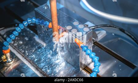 CNC machine cutting metal parts by water jet pressure Stock Photo