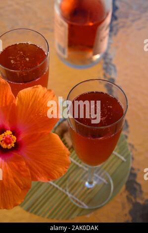 Two glasses of rose bubbles champagne or cava wine romantic served with pink hibiscus flower Stock Photo