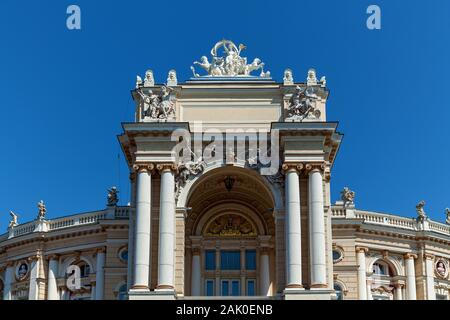 Panoramic view of the oldest theatre in Odessa with beautifully decorated elements near the green park on a sunny summer day. Stock Photo
