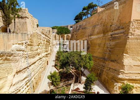An amazing view of the medieval stone fortress with a beautiful green planting in Malta. Stock Photo