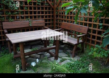 garden gazebo sheltered by azure walls with a table and benches Stock Photo