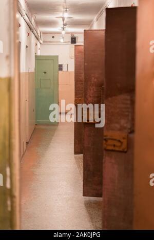 Vilnius, Lithuania: Museum of Occupations and Freedom Fights (KGB museum or Museum of Genocide Victims), prison corridor hallway, open doors of cells Stock Photo