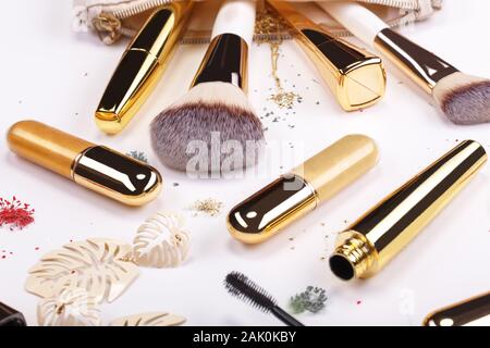 Set of brushes and cosmetic products in a cosmetic bag on a white background Stock Photo