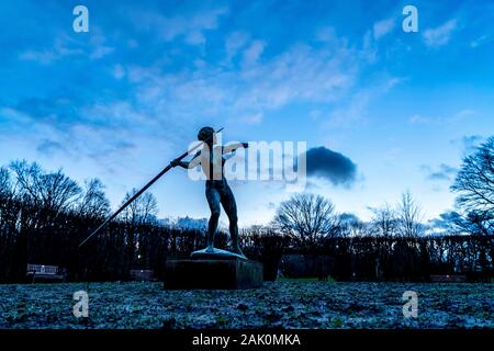 The Grugapark, in the evening, in winter, work of art The javelin thrower, in the Lindenrund, Essen, Stock Photo
