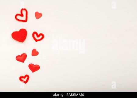 Valentines day card with copy space, frame. White wooden background with red hearts. Concept of Valentine Day, Love, romance, Heart. Valentines day Stock Photo