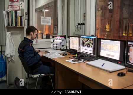 Engineer in control room of glass factory. Tyumen Stock Photo