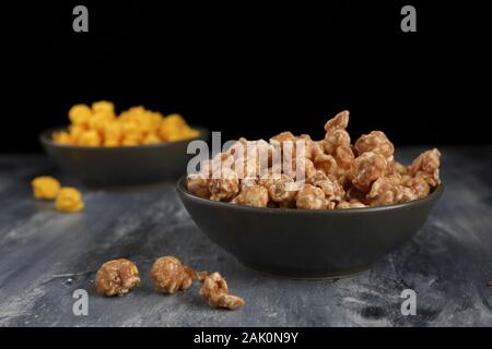A close up of caramel popcorn in a shallow green bowl taken in the studio. Stock Photo