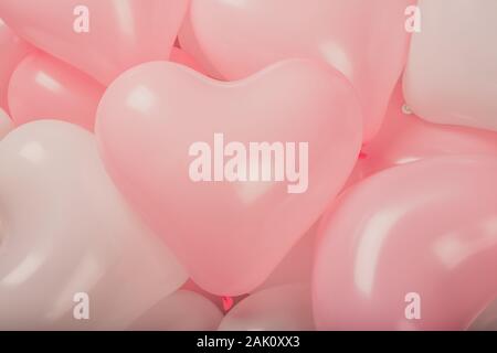 Happy valentines day greetings many heart shaped pink and white balloons background Stock Photo