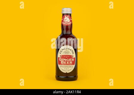 A bottle of Fentimans Ginger Beer shot on a yellow background. Stock Photo