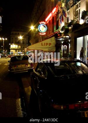 PARIS CAR - LUXURIOUS LIMOUSINE AND SPORT CAR PARKED NEAR BRASSERIE LIPP FAMOUS RESTAURANT IN ST GERMAIN DES PRÉS AT NIGHT TIME - PARIS BOULEVARD ST GERMAIN © Frédéric BEAUMONT Stock Photo