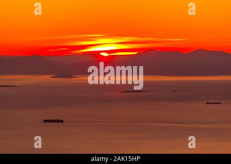 Sunset in Saronic gulf, near Athens, capital of Greece, and close to the port of Piraeus, Europe Stock Photo